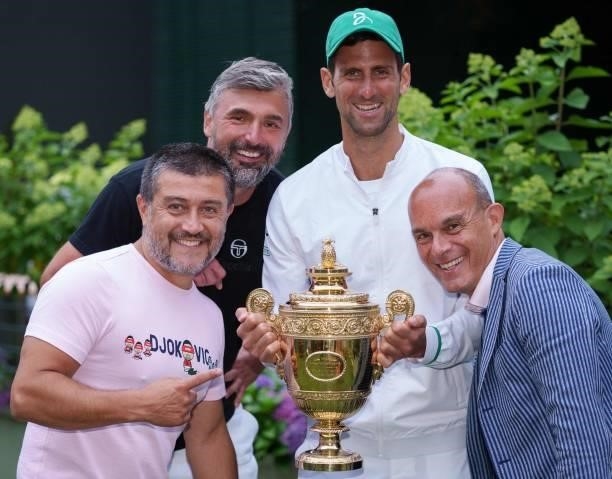 Serbia's Novak Djokovic and his and his team, including coach Goran Ivanisevic , Edoardo Artaldi , and Ulises Badio, pose with the winner's trophy on...