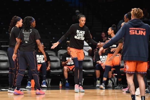 DeWanna Bonner of the Connecticut Sun high fives teammates before the game against the New York Liberty on July 11, 2021 at the Barclays Center in...