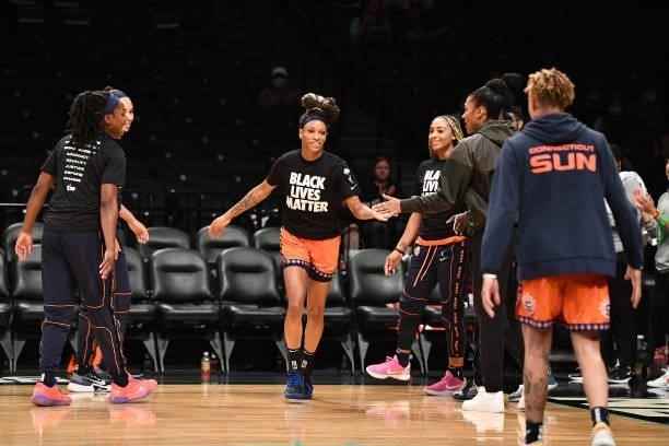Jasmine Thomas of the Connecticut Sun high fives teammates before the game against the New York Liberty on July 11, 2021 at the Barclays Center in...