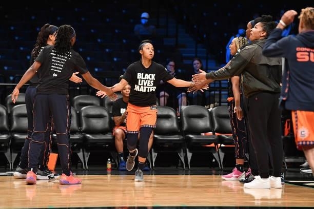 Briann January of the Connecticut Sun high fives teammates before the game against the New York Liberty on July 11, 2021 at the Barclays Center in...
