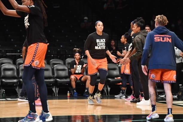 Brionna Jones of the Connecticut Sun high fives teammates before the game against the New York Liberty on July 11, 2021 at the Barclays Center in...