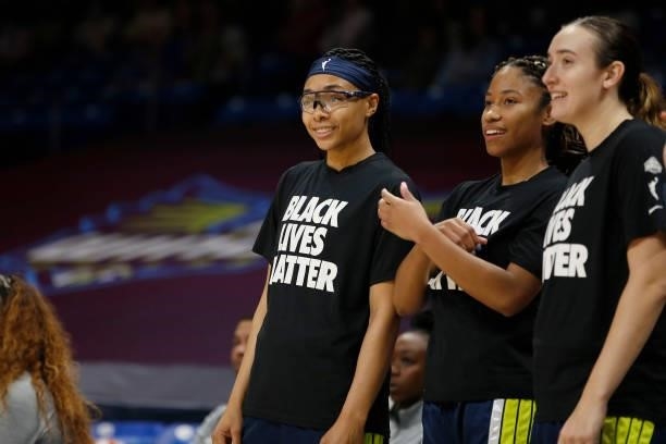 Allisha Gray of the Dallas Wings and teammates Tyasha Harris and Marina Mabrey smile before the game against the Las Vegas Aces on July 11, 2021 at...