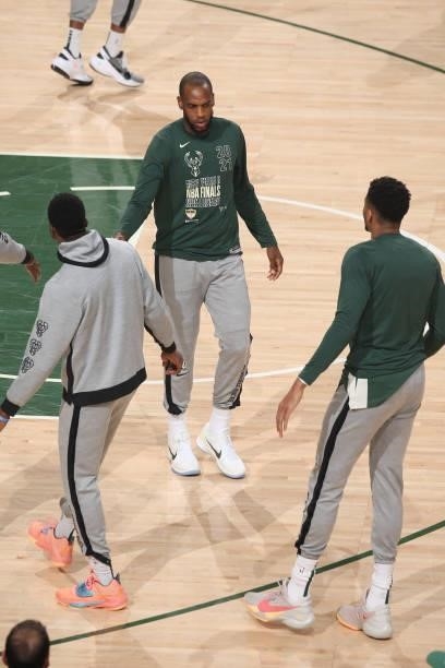 Khris Middleton of the Milwaukee Bucks high-fives teammates before the game against the Phoenix Suns during Game Three of the 2021 NBA Finals on July...