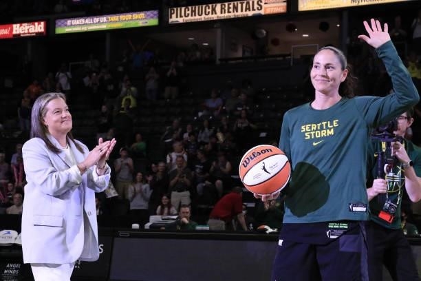 Seattle Storm CEO & President, Alisha Valavanis presents Sue Bird of the Seattle Storm with a ball to recognize becoming the first WNBA player in...