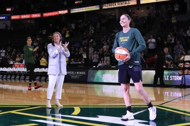 Seattle Storm CEO & President, Alisha Valavanis presents Sue Bird of the Seattle Storm with a ball to recognize becoming the first WNBA player in...