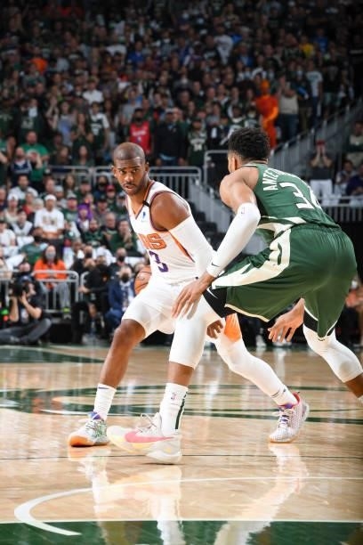 Chris Paul of the Phoenix Suns handles the ball as Giannis Antetokounmpo of the Milwaukee Bucks plays defense during Game Three of the 2021 NBA...