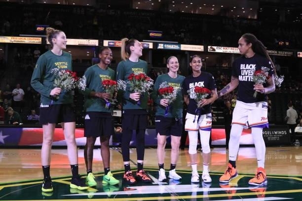 Members that will represent the USA olympic team from the Seattle Storm and the Phoenix Mercury are honored before the game on July 11, 2021 at the...