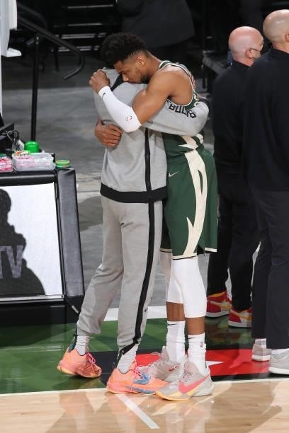 Brothers Thanasis Antetokounmpo and Giannis Antetokounmpo of the Milwaukee Bucks hug before the game against the Phoenix Suns during Game Three of...
