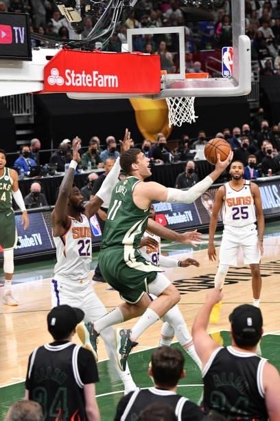 Brook Lopez of the Milwaukee Bucks shoots the ball against the Phoenix Suns during Game Three of the 2021 NBA Finals on July 11, 2021 at Fiserv Forum...