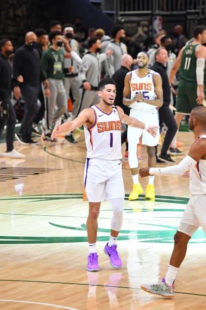 Devin Booker of the Phoenix Suns high-fives teammates during Game Three of the 2021 NBA Finals on July 11, 2021 at Fiserv Forum in Milwaukee,...