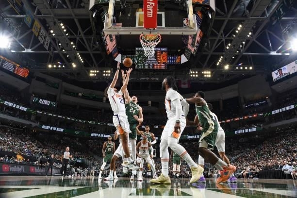 Cameron Johnson of the Phoenix Suns and Pat Connaughton of the Milwaukee Bucks fight for the rebound during Game Three of the 2021 NBA Finals on July...