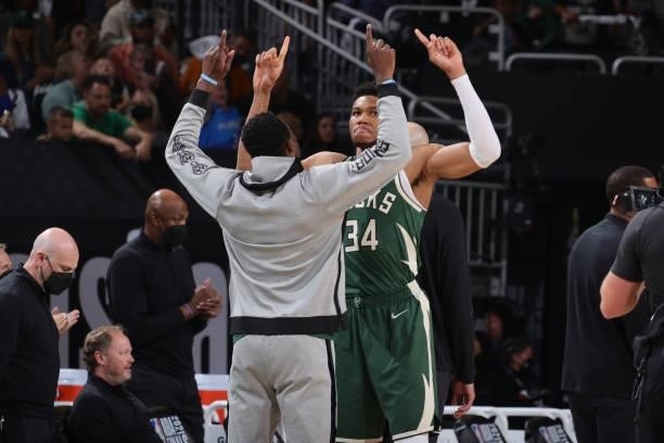 Thanasis Antetokounmpo hi-fives Giannis Antetokounmpo of the Milwaukee Bucks before the game during Game Three of the 2021 NBA Finals on July 11,...