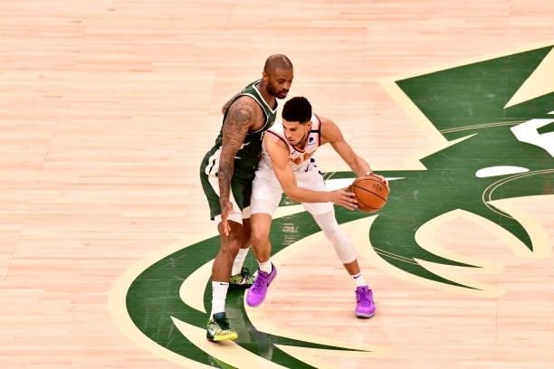 July 11: P.J. Tucker of the Milwaukee Bucks plays defense on Devin Booker of the Phoenix Suns during Game Three of the 2021 NBA Finals on July 11,...