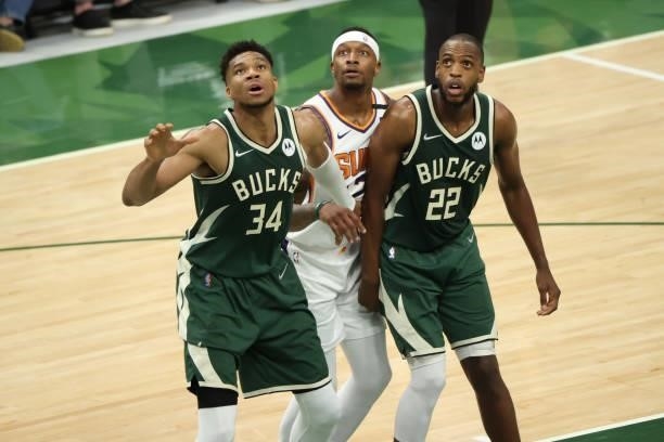 Giannis Antetokounmpo and Khris Middleton of the Milwaukee Bucks plays defense during the game against the Phoenix Suns during Game Three of the 2021...
