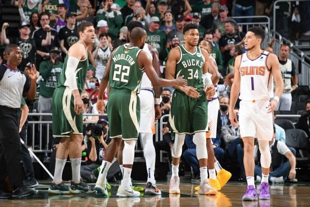 Khris Middleton of the Milwaukee Bucks high fives Giannis Antetokounmpo of the Milwaukee Bucks during the game against the Phoenix Suns during Game...