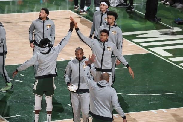 Giannis Antetokounmpo of the Milwaukee Bucks high-fives teammates before the game against the Phoenix Suns during Game Three of the 2021 NBA Finals...
