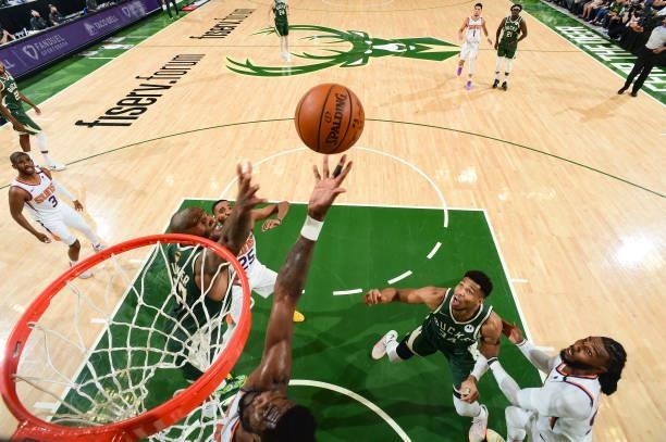 Tucker of the Milwaukee Bucks and Deandre Ayton of the Phoenix Suns fight for the rebound during Game Three of the 2021 NBA Finals on July 11, 2021...