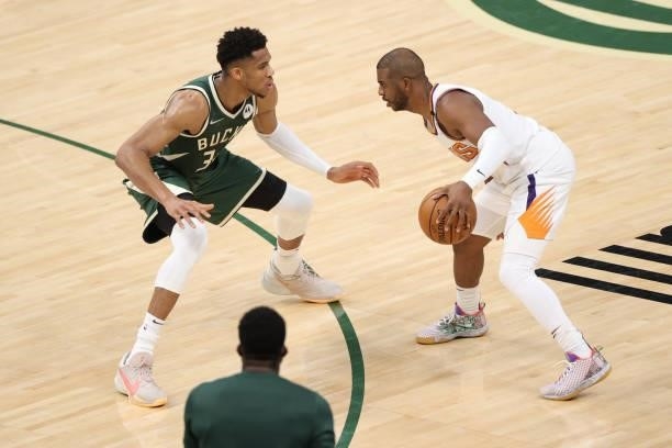 Giannis Antetokounmpo of the Milwaukee Bucks plays defense during the game against Chris Paul of the Phoenix Suns during Game Three of the 2021 NBA...