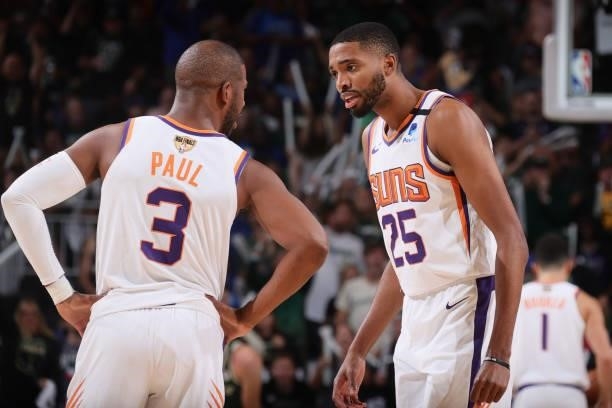 Mikal Bridges talks with Chris Paul of the Phoenix Suns during Game Three of the 2021 NBA Finals on July 11, 2021 at the Fiserv Forum Center in...