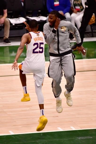 July 11: Jae Crowder of the Phoenix Suns high fives Mikal Bridges of the Phoenix Suns prior to the game against the Milwaukee Bucks during Game Three...