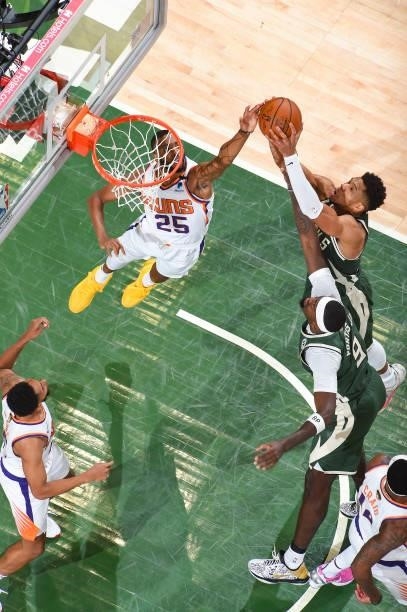 Mikal Bridges of the Phoenix Suns and Giannis Antetokounmpo of the Milwaukee Bucks fight for the rebound during Game Three of the 2021 NBA Finals on...