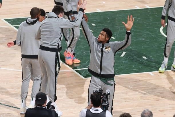 Giannis Antetokounmpo of the Milwaukee Bucks high-fives teammates before the game against the Phoenix Suns during Game Three of the 2021 NBA Finals...
