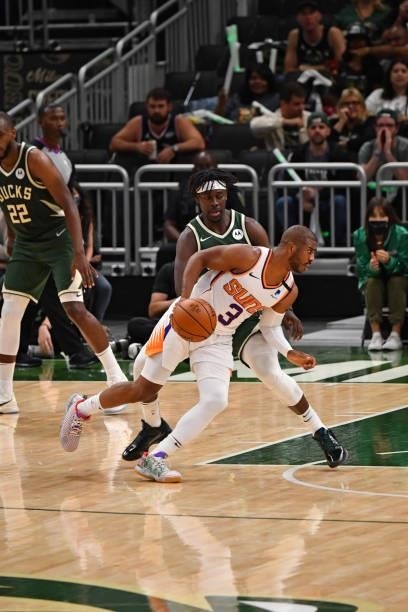 Chris Paul of the Phoenix Suns handles the ball against Jrue Holiday of the Milwaukee Bucks during Game Three of the 2021 NBA Finals on July 11, 2021...