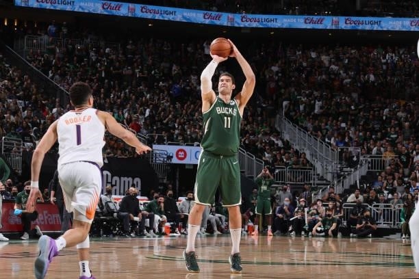 Brook Lopez of the Milwaukee Bucks shoots a three point basket against the Phoenix Suns during Game Three of the 2021 NBA Finals on July 11, 2021 at...
