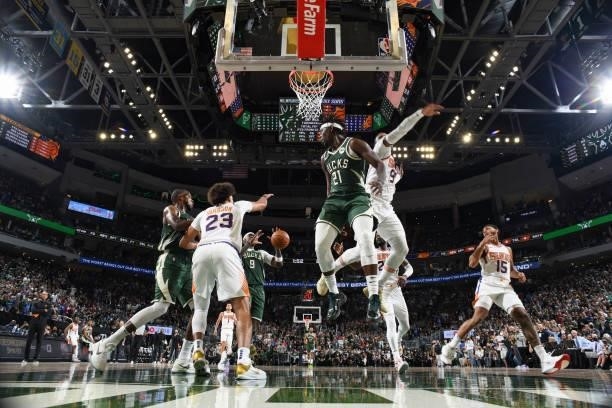 Jrue Holiday of the Milwaukee Bucks passes the ball to Bobby Portis of the Milwaukee Bucks during the game against the Phoenix Suns during Game Three...