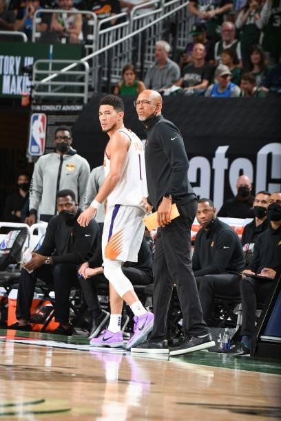 Devin Booker of the Phoenix Suns talks to Head Coach Monty Williams of the Phoenix Suns during the game against the Milwaukee Bucks during Game Three...