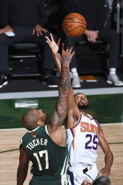 July 11: P.J. Tucker of the Milwaukee Bucks and Mikal Bridges of the Phoenix Suns jump for a tip ball during Game Three of the 2021 NBA Finals on...