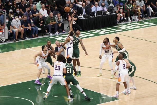 Mikal Bridges of the Phoenix Suns and P.J. Tucker of the Milwaukee Bucks fight for possession during Game Three of the 2021 NBA Finals on July 11,...