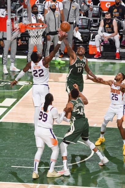 Deandre Ayton of the Phoenix Suns and P.J. Tucker of the Milwaukee Bucks fight for the rebound during Game Three of the 2021 NBA Finals on July 11,...