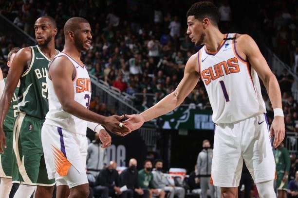 Chris Paul hi-fives Devin Booker of the Phoenix Suns during Game Three of the 2021 NBA Finals on July 11, 2021 at the Fiserv Forum Center in...