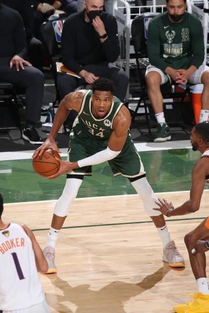 Giannis Antetokounmpo of the Milwaukee Bucks handles the ball during the game against the Phoenix Suns during Game Three of the 2021 NBA Finals on...