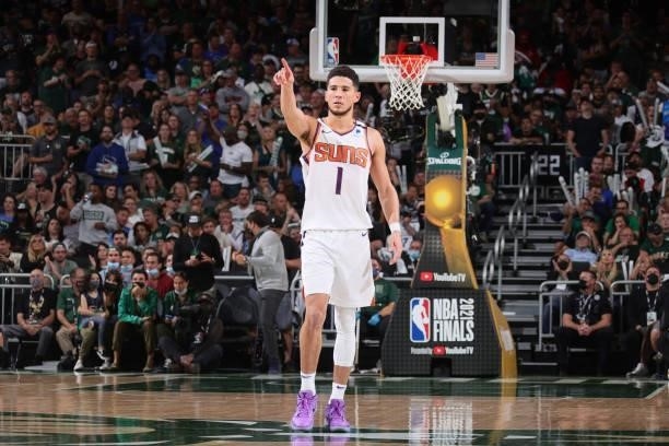 Devin Booker of the Phoenix Suns looks on during Game Three of the 2021 NBA Finals on July 11, 2021 at the Fiserv Forum Center in Milwaukee,...