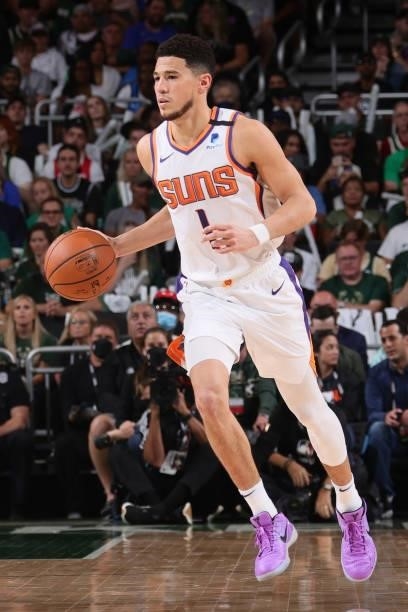 Devin Booker of the Phoenix Suns dribbles the ball during Game Three of the 2021 NBA Finals on July 11, 2021 at the Fiserv Forum Center in Milwaukee,...