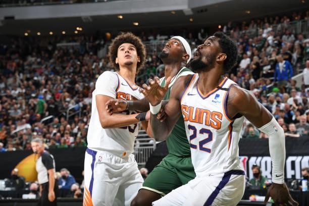 Cameron Johnson of the Phoenix Suns, Bobby Portis of the Milwaukee Bucks and Deandre Ayton of the Phoenix Suns fight for position during Game Three...