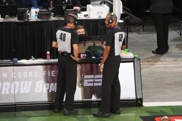 Officials Scott Foster and Eric Lewis review video during the Milwaukee Bucks game against the Phoenix Suns during Game Three of the 2021 NBA Finals...