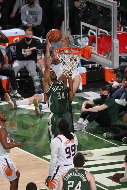 Giannis Antetokounmpo of the Milwaukee Bucks reaches for a rebound during the game against the Phoenix Suns during Game Three of the 2021 NBA Finals...