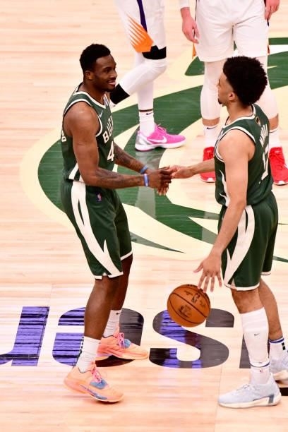 July 11: Thanasis Antetokounmpo of the Milwaukee Bucks high fives Jordan Nwora of the Milwaukee Bucks during Game Three of the 2021 NBA Finals on...