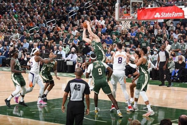 Pat Connaughton of the Milwaukee Bucks rebounds the ball during the game against the Phoenix Suns during Game Three of the 2021 NBA Finals on July...