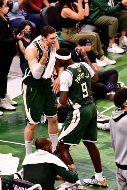 July 11: Brook Lopez of the Milwaukee Bucks high fives Bobby Portis of the Milwaukee Bucks during Game Three of the 2021 NBA Finals on July 11, 2021...