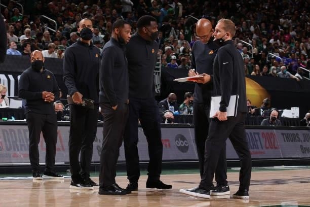 Head Coach Monty Williams of the Phoenix Suns talks with his coaching staff during Game Three of the 2021 NBA Finals on July 11, 2021 at the Fiserv...