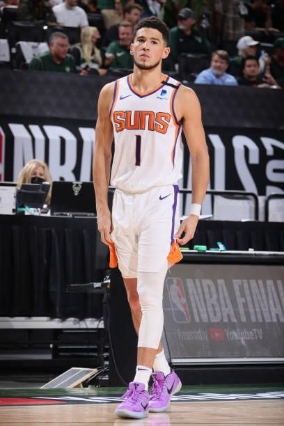 Devin Booker of the Phoenix Suns looks on during Game Three of the 2021 NBA Finals on July 11, 2021 at the Fiserv Forum Center in Milwaukee,...