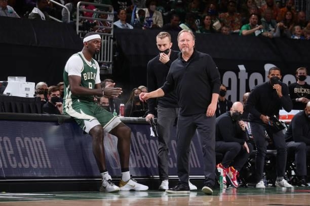 Head Coach Mike Budenholzer of the Milwaukee Bucks talks with assistant coach Patrick St. Andrews and Bobby Portis during Game Three of the 2021 NBA...