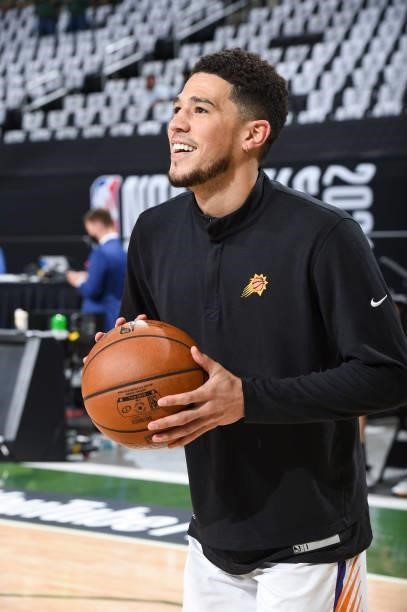Devin Booker of the Phoenix Suns smiles before the game against the Milwaukee Bucks during Game Three of the 2021 NBA Finals on July 11, 2021 at the...