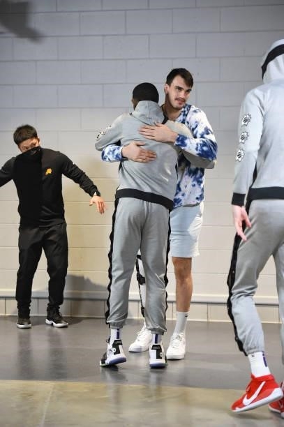 Twaun Moore of the Phoenix Suns hugs Dario Saric of the Phoenix Suns before the game against the Milwaukee Bucks during Game Three of the 2021 NBA...