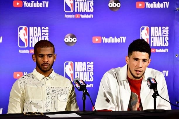 July 11: Devin Booker of the Phoenix Suns and Chris Paul of the Phoenix Suns talk to the media after the game against the Milwaukee Bucks during Game...
