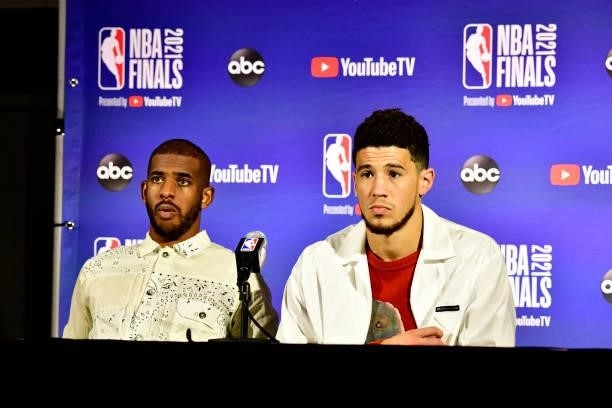 July 11: Devin Booker of the Phoenix Suns and Chris Paul of the Phoenix Suns talk to the media after the game against the Milwaukee Bucks during Game...